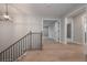 Light-filled hallway with hardwood floors, modern light fixture, and staircase with black metal railing at 6861 Ga Hwy 5, Douglasville, GA 30135