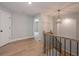 Upstairs hallway with hardwood floors and railing at 6861 Ga Hwy 5, Douglasville, GA 30135