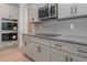 Modern kitchen featuring gray cabinets, granite countertops, stainless steel appliances, and herringbone backsplash at 6861 Ga Hwy 5, Douglasville, GA 30135