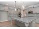 Kitchen with gray cabinets, stainless steel appliances, a large island, and granite countertops, and pendant lighting at 6861 Ga Hwy 5, Douglasville, GA 30135