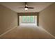 Spacious living room featuring a ceiling fan and beautiful green backyard at 6861 Ga Hwy 5, Douglasville, GA 30135