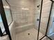 Modern shower design featuring gray tiling, a black frame, and built-in seating at 6861 Ga Hwy 5, Douglasville, GA 30135