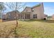 Home's backyard featuring a screened porch, and lush landscaping at 3257 Alhambra Cir, Hampton, GA 30228