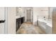 Bathroom featuring double vanity, tile flooring, soaking tub, and decorative lighting at 3257 Alhambra Cir, Hampton, GA 30228