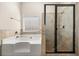 Bathroom featuring glass enclosed shower, soaking tub and neutral tile at 3257 Alhambra Cir, Hampton, GA 30228