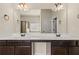 Bathroom vanity with double sinks, a large mirror, and dark wood cabinets at 3257 Alhambra Cir, Hampton, GA 30228