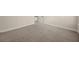 Spacious bedroom featuring neutral walls, plush carpeting, and a convenient doorway at 3257 Alhambra Cir, Hampton, GA 30228