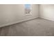 Cozy bedroom featuring a window, neutral walls, and plush carpeting at 3257 Alhambra Cir, Hampton, GA 30228