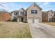 Two-story brick home with a two-car garage and covered front porch at 3257 Alhambra Cir, Hampton, GA 30228