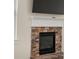 Stone fireplace with white mantel, beneath a wall-mounted TV in a bright room at 3257 Alhambra Cir, Hampton, GA 30228