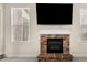 Stone fireplace with a TV mounted above in a sun-filled living room at 3257 Alhambra Cir, Hampton, GA 30228