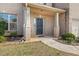 A covered front porch featuring the house number, a black door and green bushes at 3257 Alhambra Cir, Hampton, GA 30228