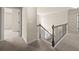 Upstairs hallway featuring neutral carpet, trim, and decor with an opening to an adjacent room at 3257 Alhambra Cir, Hampton, GA 30228