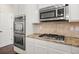 Gourmet kitchen with granite counters, stainless steel appliances, double ovens and a gas cooktop at 3257 Alhambra Cir, Hampton, GA 30228