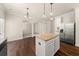 Kitchen island, stainless steel refrigerator, and hardwood floors create a gourmet experience at 3257 Alhambra Cir, Hampton, GA 30228