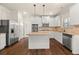 Kitchen with white cabinets, stainless steel appliances, granite countertops, and hardwood floors at 3257 Alhambra Cir, Hampton, GA 30228