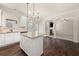 A kitchen featuring a granite island, stainless appliances, and an archway to a fireplace at 3257 Alhambra Cir, Hampton, GA 30228