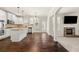 A bright kitchen with stainless appliances, a granite island and an archway to the living room at 3257 Alhambra Cir, Hampton, GA 30228
