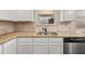 Kitchen sink with granite counters and stainless steel dishwasher at 3257 Alhambra Cir, Hampton, GA 30228