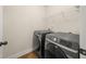 Laundry room featuring modern gray front load washer and dryer with wire rack shelving at 3257 Alhambra Cir, Hampton, GA 30228