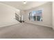A spacious carpeted living room with many windows and a staircase at 3257 Alhambra Cir, Hampton, GA 30228