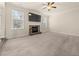 Bright living room with fireplace, large windows, and plush carpeting at 3257 Alhambra Cir, Hampton, GA 30228