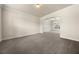 A spacious carpeted living room featuring archways to the dinning area at 3257 Alhambra Cir, Hampton, GA 30228