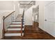 An interior shot of a staircase with a wooden handrail and hardwood flooring at 3257 Alhambra Cir, Hampton, GA 30228