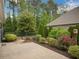 Beautifully landscaped backyard with brick paver patio, shrubbery and garden at 3538 Serenade Nw Commons, Kennesaw, GA 30152