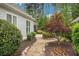 Stone path winds through the landscaped backyard with green shrubbery and colorful Japanese maple at 3538 Serenade Nw Commons, Kennesaw, GA 30152