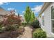 A stone walkway through the landscaped yard features a variety of shrubs and trees at 3538 Serenade Nw Commons, Kennesaw, GA 30152