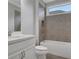 Clean bathroom featuring a tub/shower combo with tiled walls, a white vanity, and a window at 3538 Serenade Nw Commons, Kennesaw, GA 30152