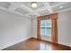Elegant bedroom showcasing hardwood floors, coffered ceiling, and natural light at 3538 Serenade Nw Commons, Kennesaw, GA 30152