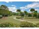 Scenic walking path through a beautifully landscaped common area with mature trees and manicured shrubs at 3538 Serenade Nw Commons, Kennesaw, GA 30152