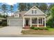 Charming home featuring a covered front porch with brick accents and a well-manicured front yard at 3538 Serenade Nw Commons, Kennesaw, GA 30152