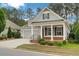 Inviting home featuring a covered porch, well-maintained lawn, and a two-car garage at 3538 Serenade Nw Commons, Kennesaw, GA 30152