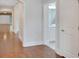 Open hallway featuring hardwood floors, white trim, and access to a bathroom with bright lighting at 3538 Serenade Nw Commons, Kennesaw, GA 30152