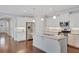Bright kitchen features white cabinetry, stainless steel appliances, granite counters, and hardwood floors at 3538 Serenade Nw Commons, Kennesaw, GA 30152