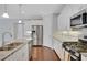 Modern kitchen with stainless steel appliances, white cabinets, granite countertops, and hardwood flooring at 3538 Serenade Nw Commons, Kennesaw, GA 30152