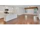 Open living space with hardwood floors, modern lighting, fireplace, and direct access to the backyard at 3538 Serenade Nw Commons, Kennesaw, GA 30152