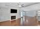 Open-concept living space with fireplace, hardwood floors, and access to kitchen at 3538 Serenade Nw Commons, Kennesaw, GA 30152
