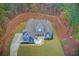 Stunning aerial view of a two-story home with a meticulously landscaped yard surrounded by mature trees at 401 Night Hawk Ct, Canton, GA 30114