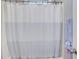 Bathroom features a white and gray striped shower curtain, door, and a mounted towel at 401 Night Hawk Ct, Canton, GA 30114