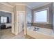 Bright bathroom featuring a soaking tub and a view to the adjacent bedroom at 401 Night Hawk Ct, Canton, GA 30114