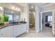 Well-lit bathroom with dual sinks, tiled shower, and view to the adjacent bedroom at 401 Night Hawk Ct, Canton, GA 30114