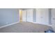 Spacious bedroom with plush gray carpet and neutral walls, complemented by ample closet space at 401 Night Hawk Ct, Canton, GA 30114