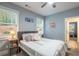 Cozy bedroom features a comfortable bed with a gray headboard and view of the landscape at 401 Night Hawk Ct, Canton, GA 30114