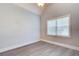 Well-lit empty bedroom with gray walls, white trim, and laminate floors at 401 Night Hawk Ct, Canton, GA 30114