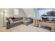Bonus room with a gray sectional couch, desk, and neutral carpet, perfect for relaxation at 401 Night Hawk Ct, Canton, GA 30114