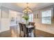 Elegant dining room with modern chandelier, natural light, and wainscotting at 401 Night Hawk Ct, Canton, GA 30114